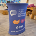 Automatic pop up counter with branded wrap and shelf.
