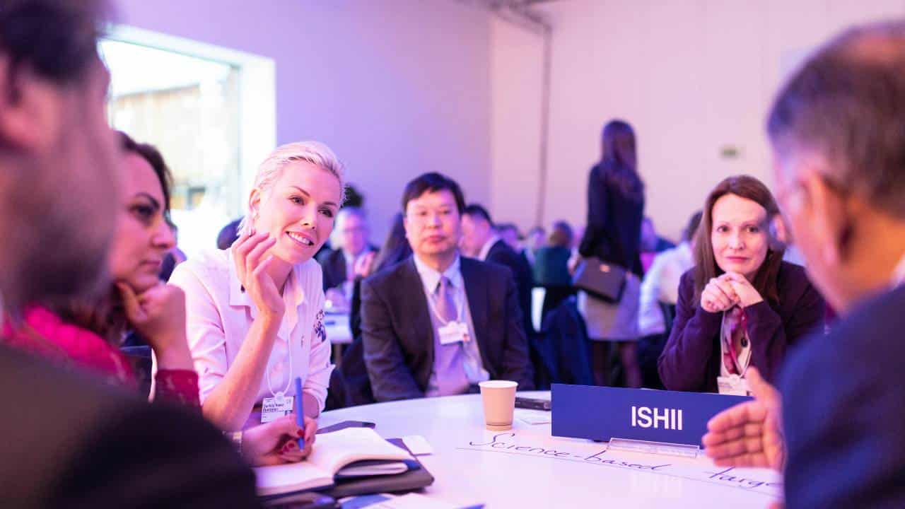 Business people talking to each other at a conference