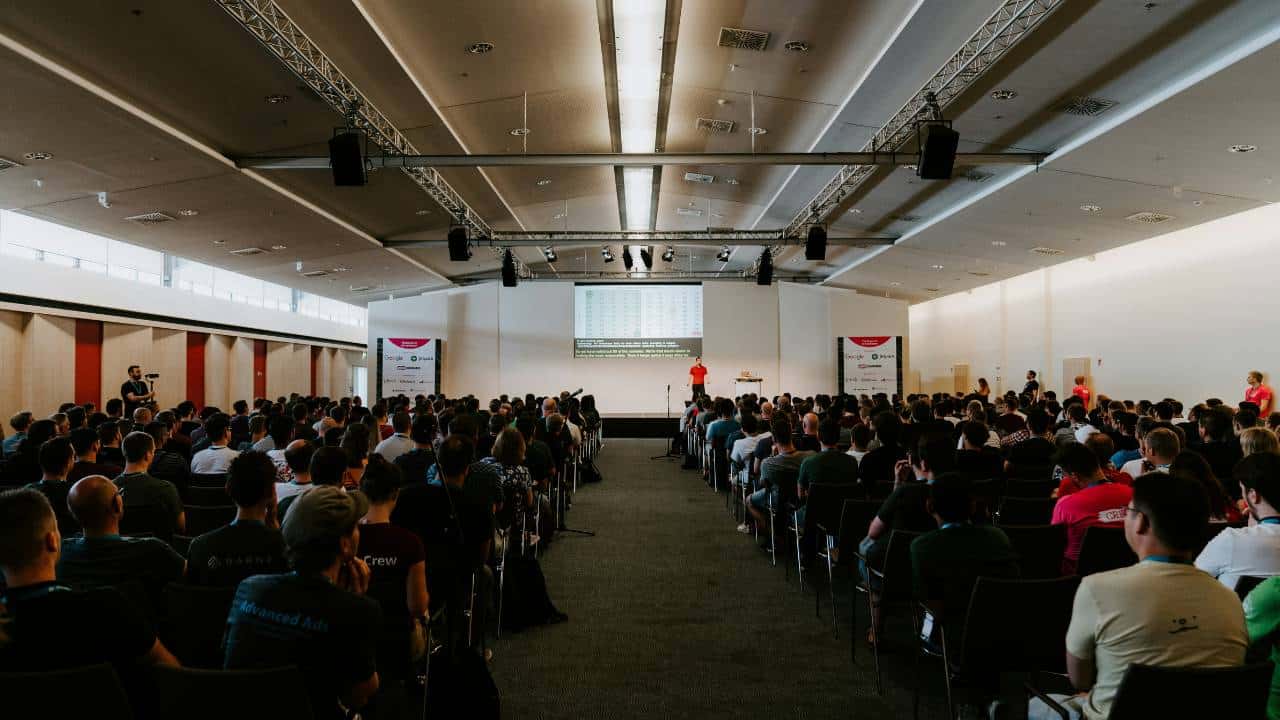A large conference room with lots of attendees