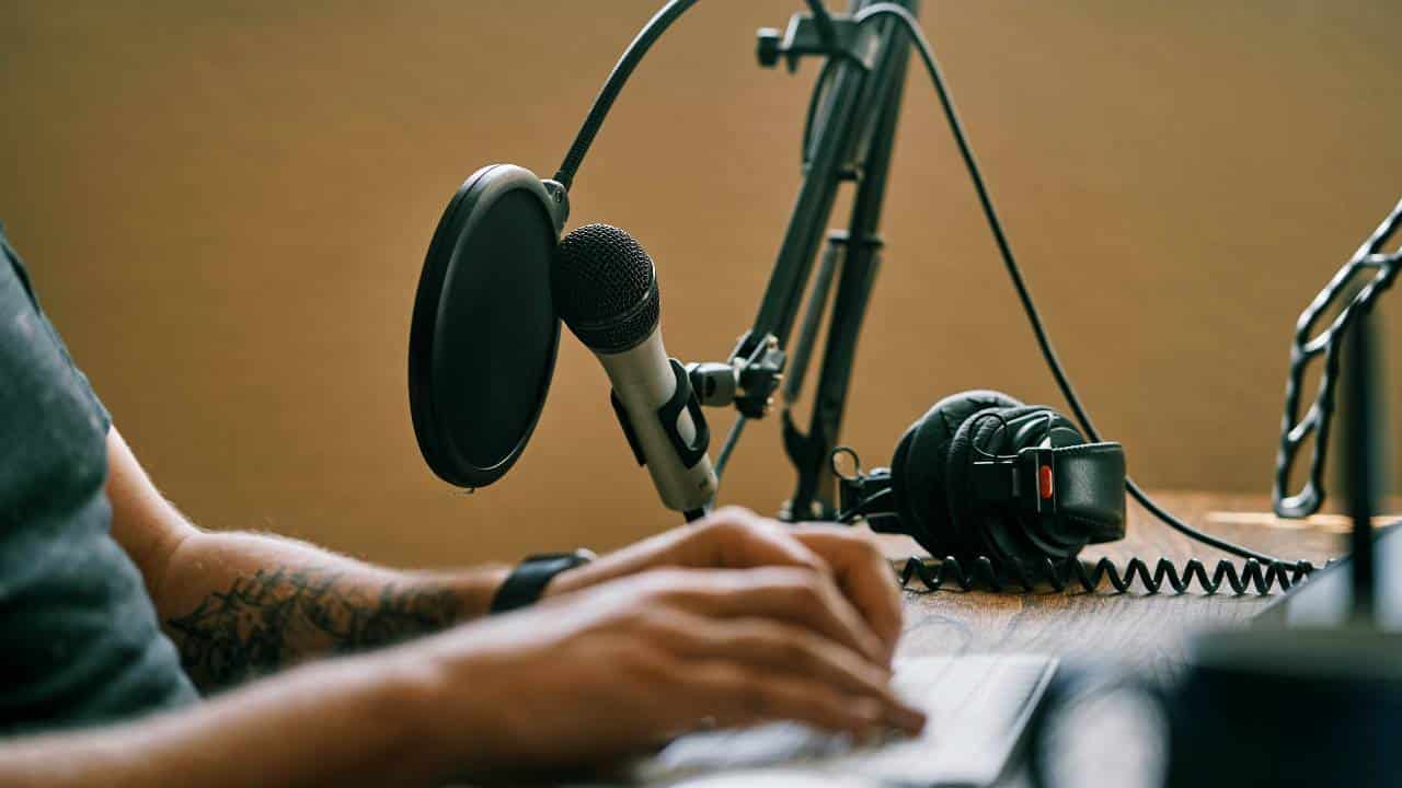 A man using a modern microphone to record a podcast