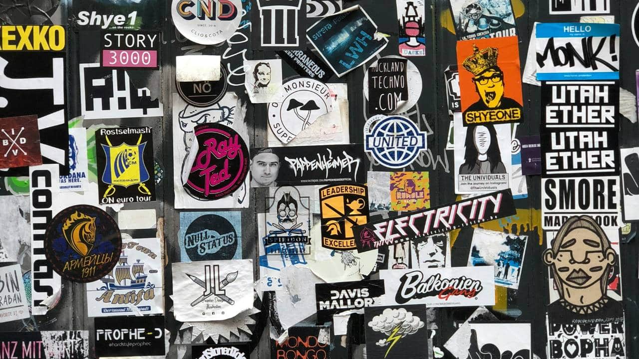 Various stickers on a black wall