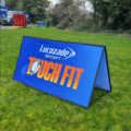 Pitch pop up display with branded graphic in sport venue.