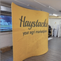 S-shape display stand with printed fabric on both sides.