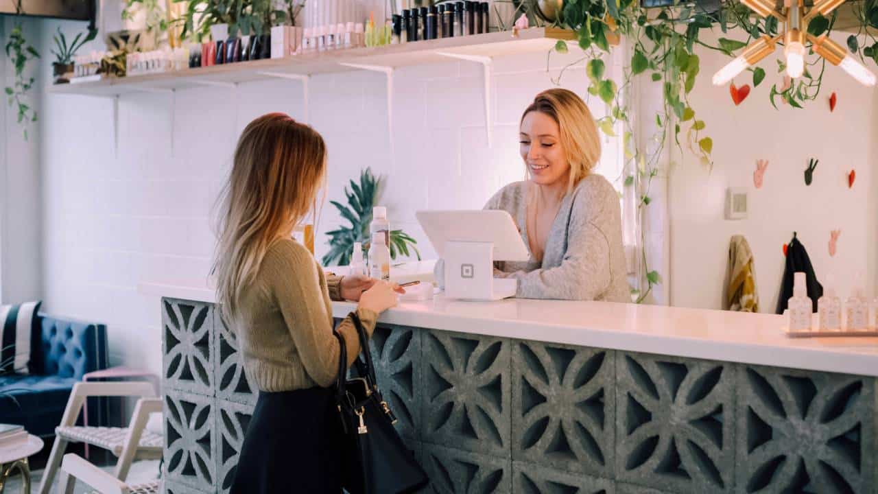 A female customer paying at the shop counter