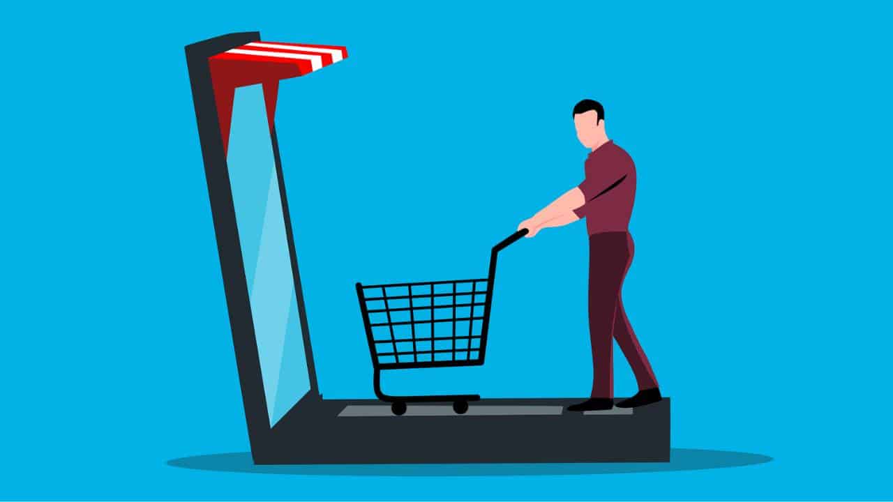 A graphic depiction of a customer pushing a shopping cart on a laptop