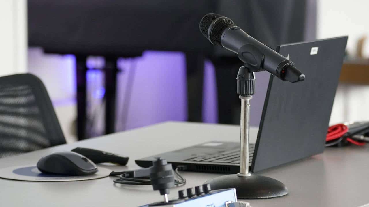 A microphone next to a laptop