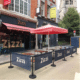 Custom branded cafe barrier for outdoor restaurant use.
