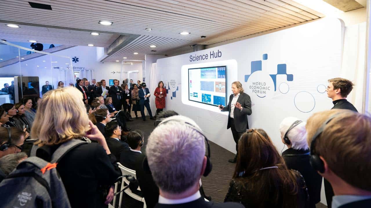A businessman talking to attendees at an industry exhibition