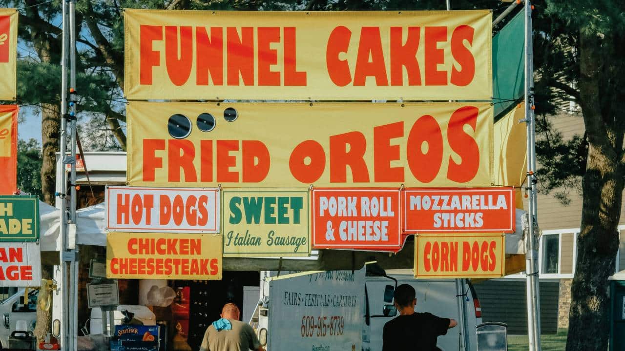 Various banners at a food-selling stand