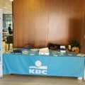 KBC branded printed tablecloth at an exhibition stand.