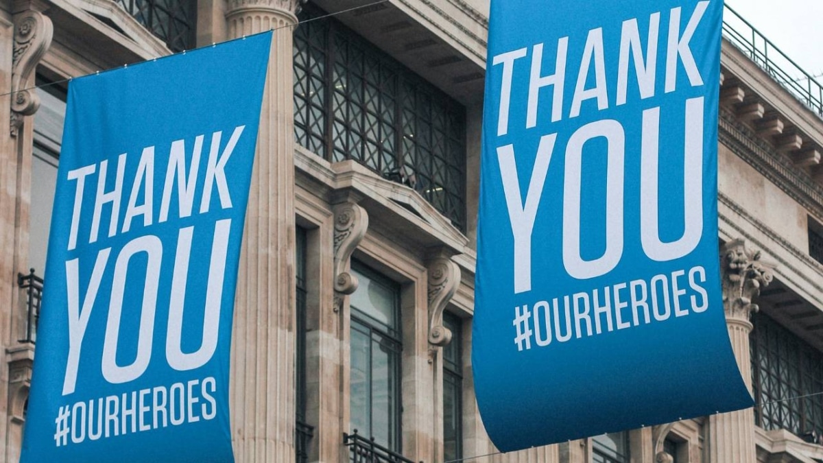 Two blue banners saying "Thank You" hanging in the middle of a street