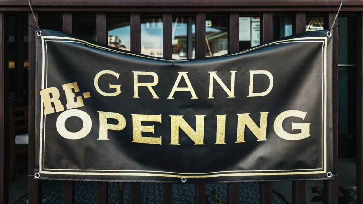 A black banner saying "Grand Re-Opening"
