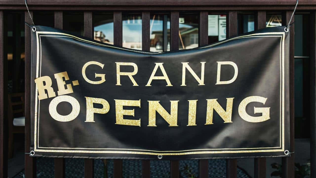 A black and yellow banner saying "grand opening"