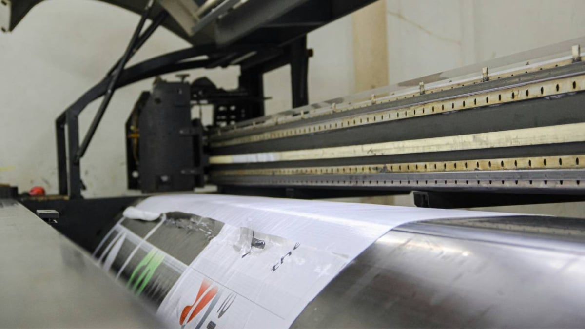 A printing machine situated inside a printing workshop