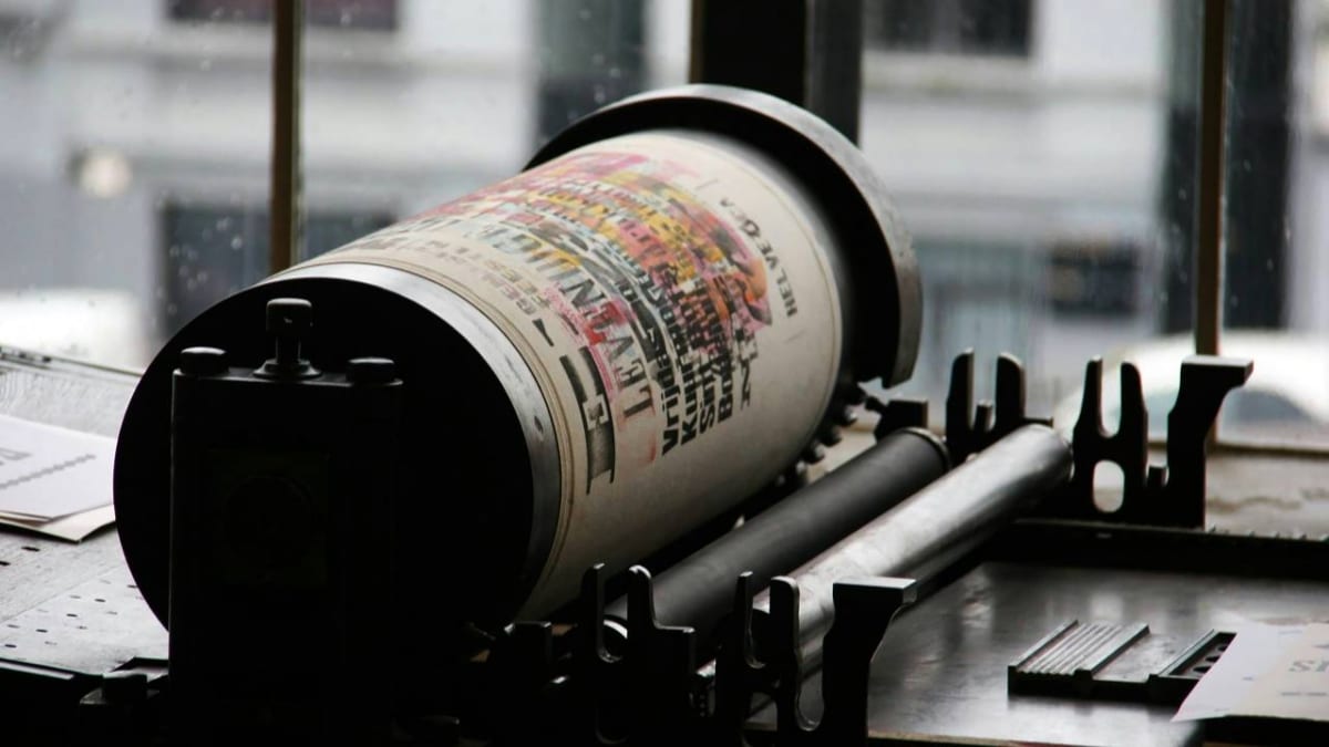 A photo of a circular-shaped, old printing machine