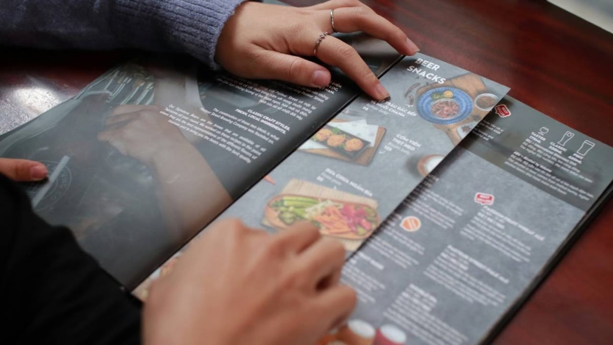 Two people looking at the menu at a restaurant