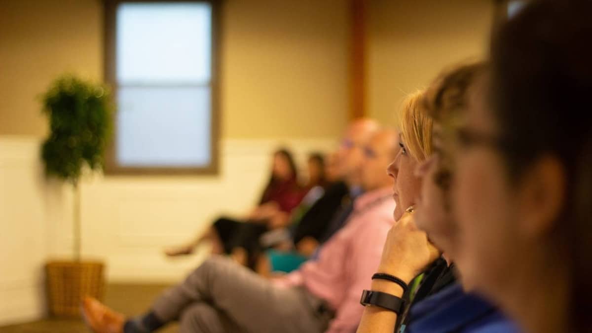 Several conference attendees listening to the speaker